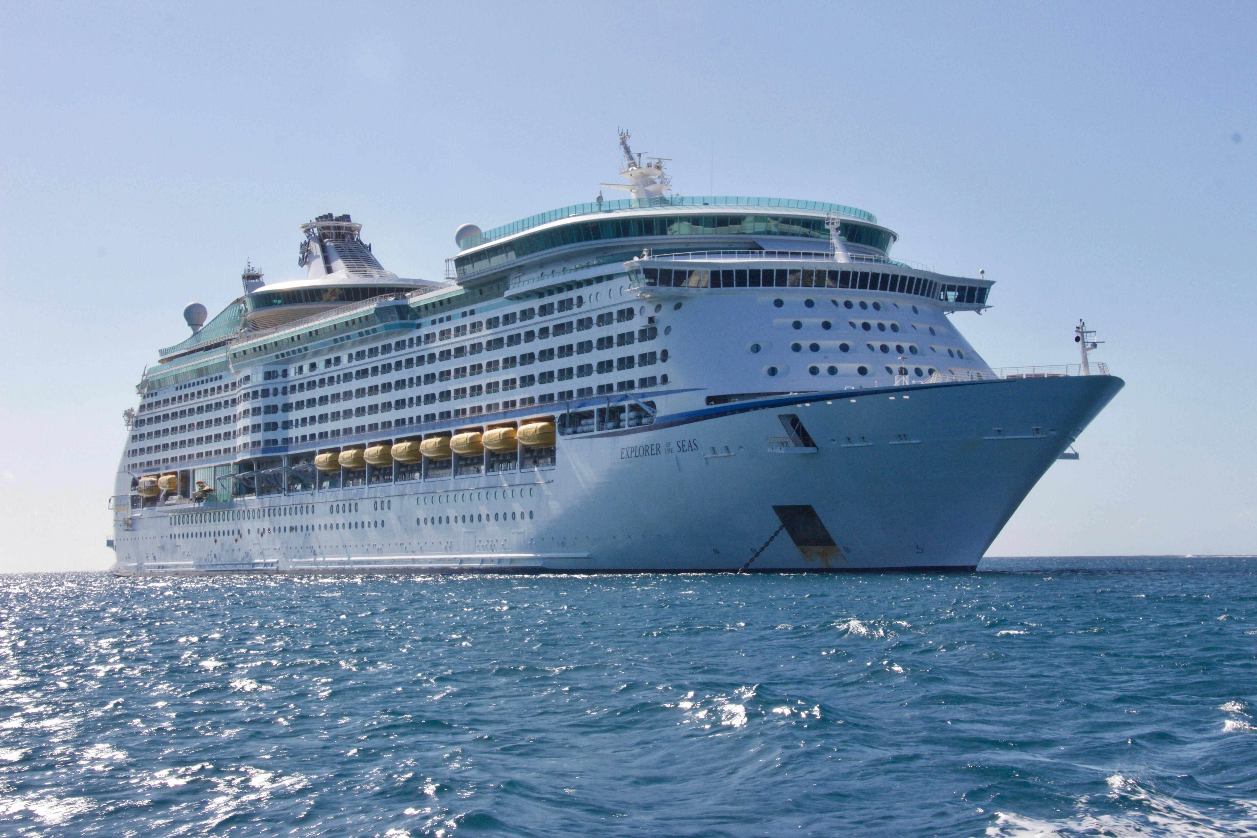 Large cruise ship sailing on a clear blue ocean