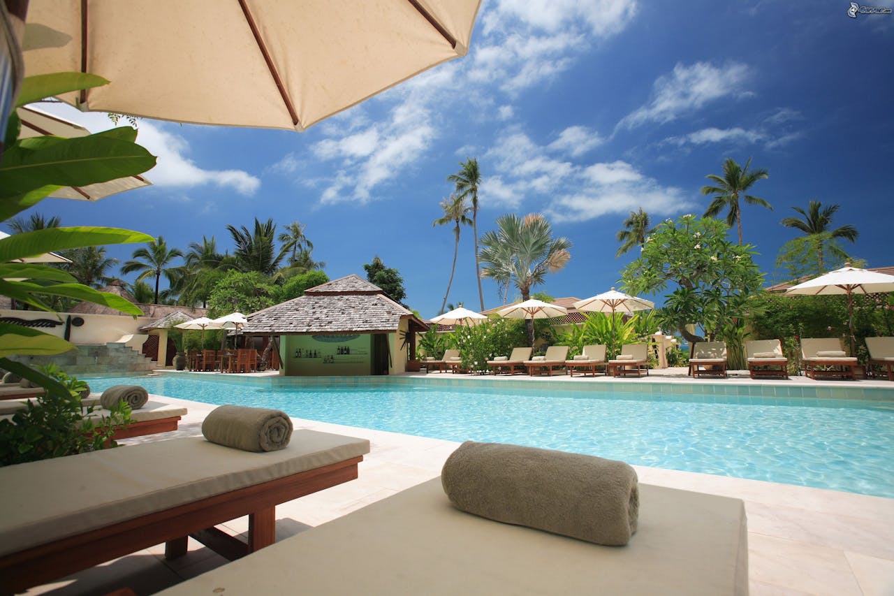 Luxury all-inclusive tropical resort with pool and palm trees